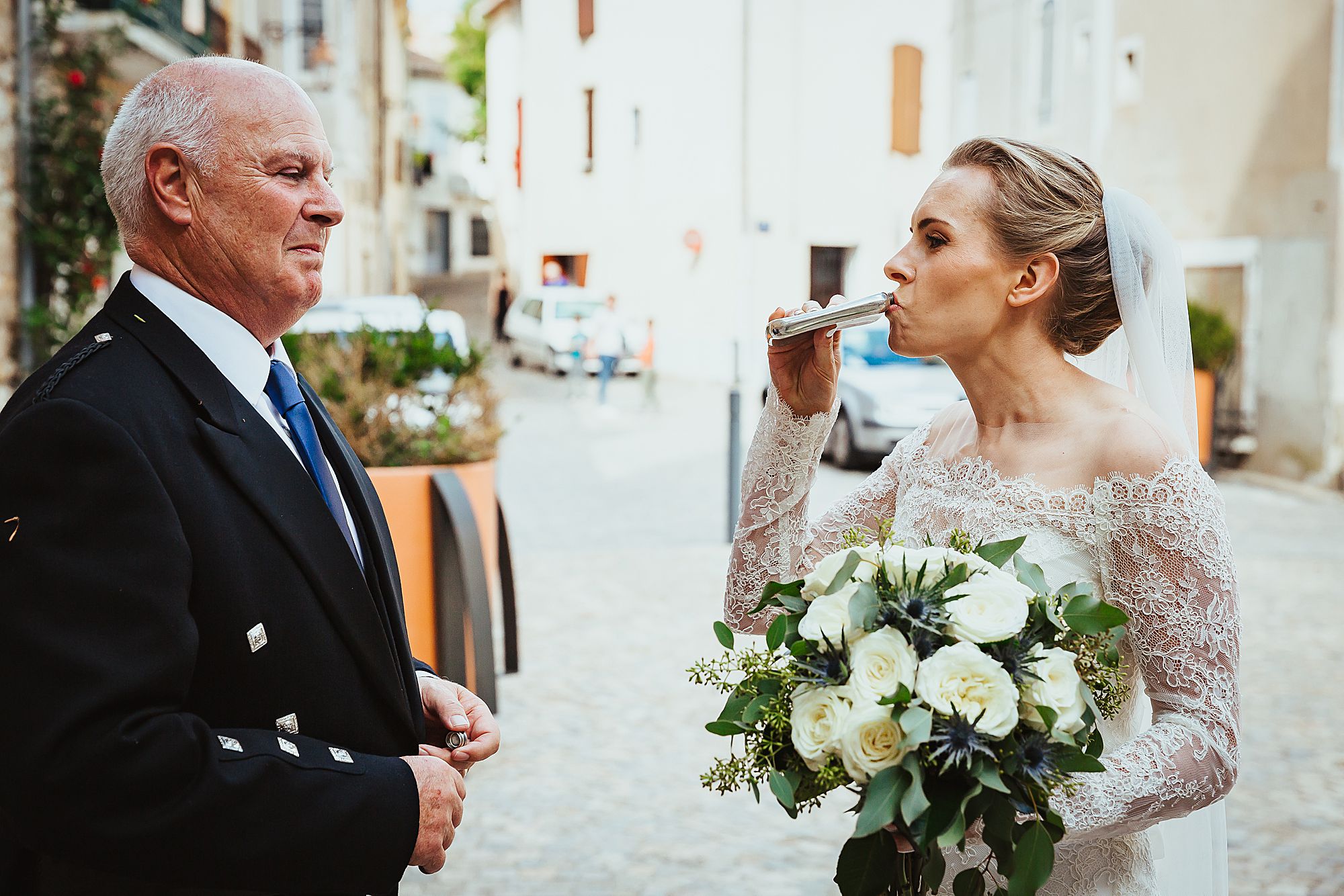 bride takes a swig of whisky before the ceremony