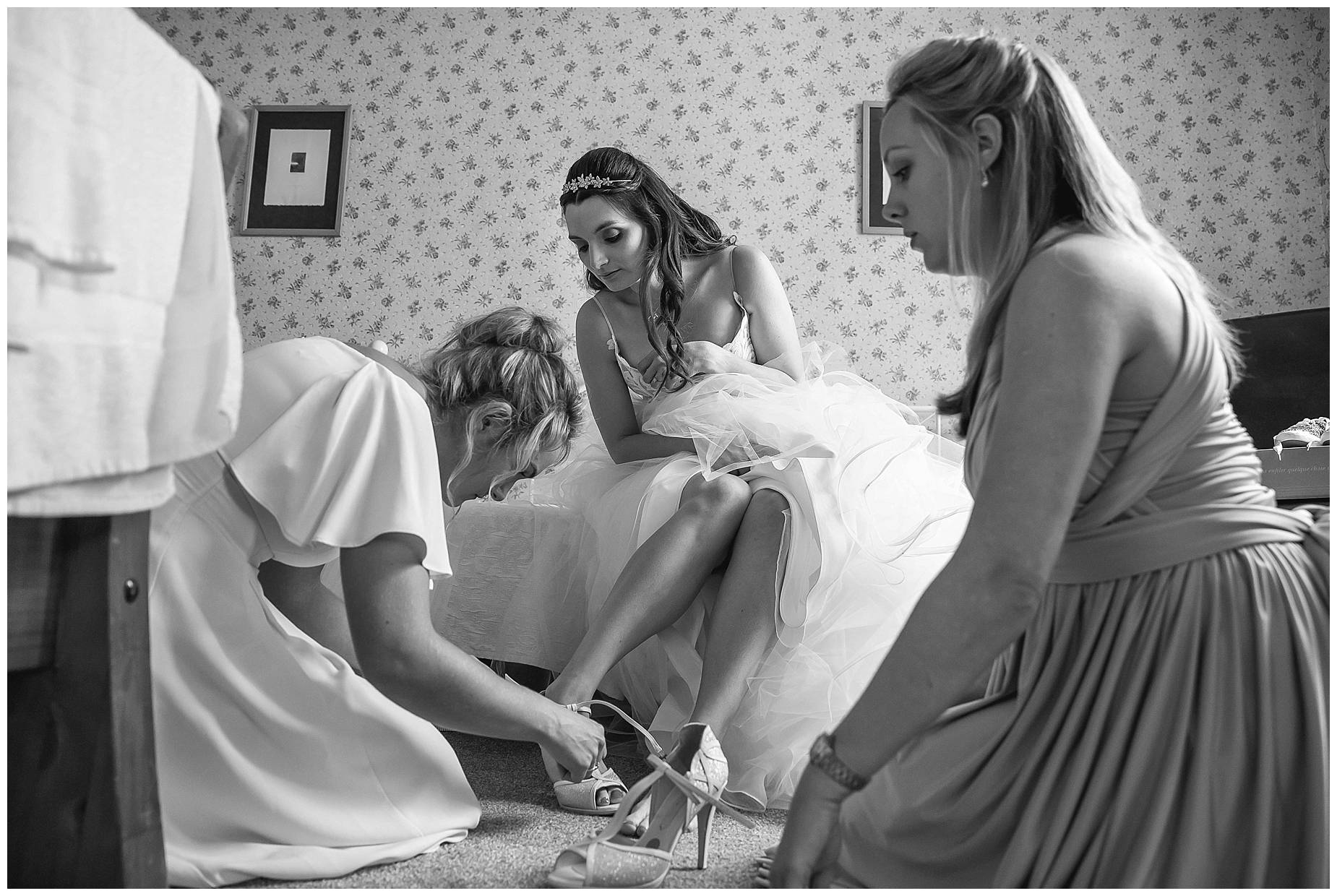 shoes being put on bride
